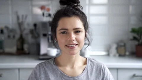 Portrait of a young brunette looking into the camera laughing and shy Stock-Footage 105113667