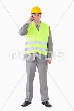 Portrait of a young builder making a phone call Stock Photos