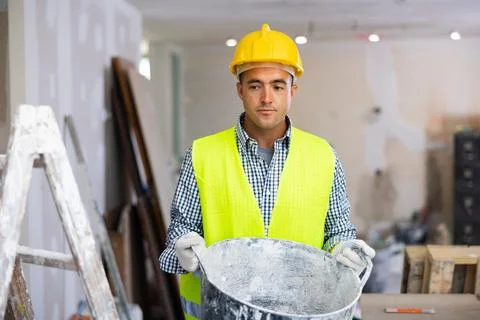Portrait of a young builder in the process of repair Stock Photos