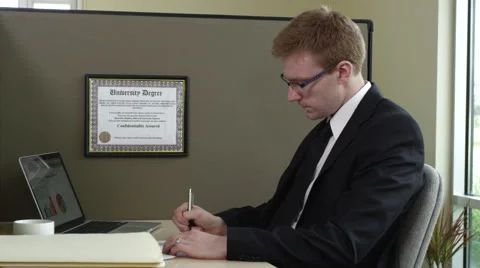 Portrait of young businessman taking notes and smiling Stock Footage 67364444