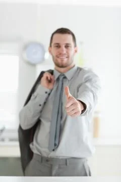 Portrait of a young businessman with the thumb up Stock Photos