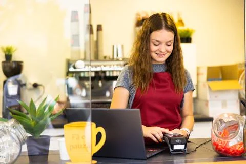 Portrait of young businesswoman working on her laptop at a coffee shop. Business Stock-Fotos