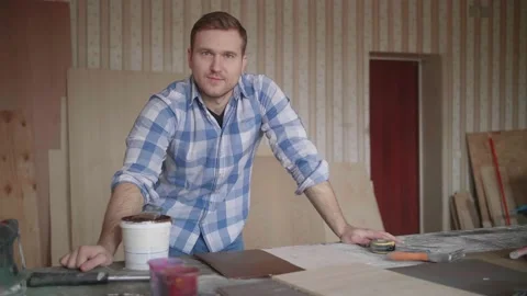 Portrait of a young carpenter behind the workplace Video stock 153492792
