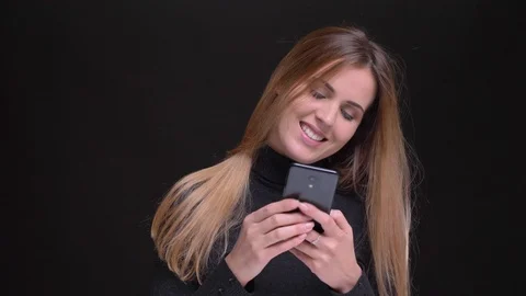 Portrait of young caucasian long-haired blonde girl smilingly watching into Video stock 101604851