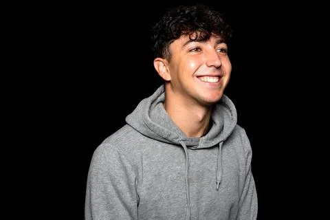 Portrait of young Caucasian man with curly hair about 25 years old, smiling.. Stock Photos