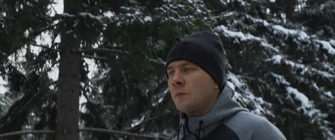 Portrait of young caucasian runner jogging in winter forest or park, workout Stock Footage 120299098