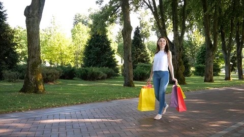Portrait young charming short-haired woman shopping bags behind background Video stock 99247969
