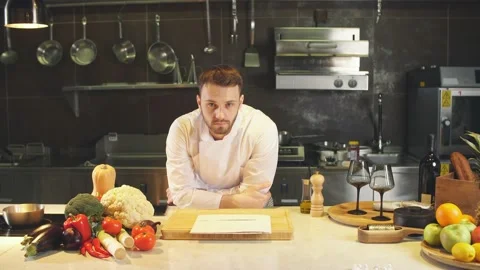 Portrait of young chef looking straight to the camera in kitchen Stock Footage 126694009