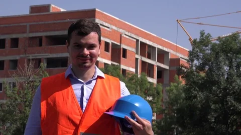 Portrait of young construction builder developer holding helmet in hand smiling Stock Footage 77189842
