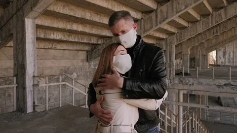 Portrait of a young couple in love in protective medical masks in the city. Stock Footage 127900537