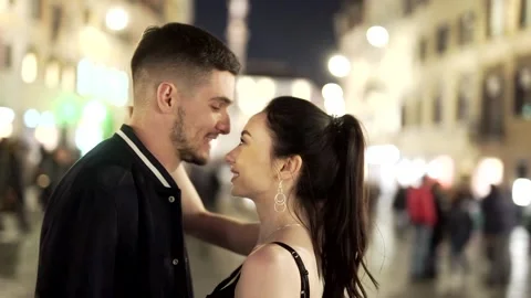 Portrait a young couple standing in the central square of the old night city Stock Footage 135671488