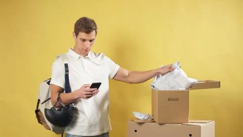 Portrait of a young courier on an isolated background with ready-made customer Stock Photos