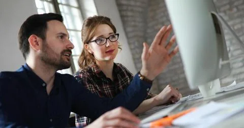 Portrait of young designers working on computer Foto stock