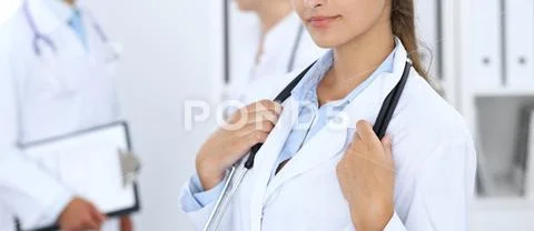 Portrait of young doctor woman in hospital. Hispanic or latin american staff i Stock Photos