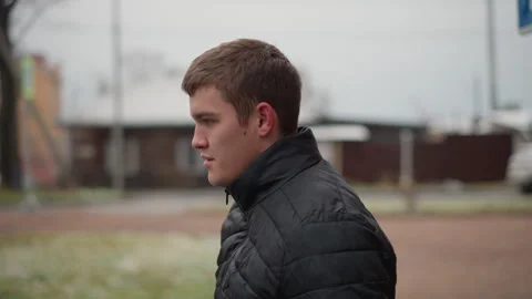 Portrait Young Driver in Black Winter Coat and Blue Jeans on Urban Pavement Stock Footage 310514606