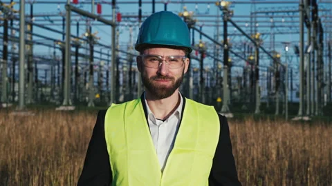 Portrait of young electric engineer wearing helmet suit and safety vest with Stock Footage 171191018