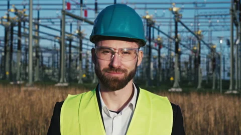 Portrait of young electric engineer wearing helmet suit and safety vest with Stock Footage 171191226