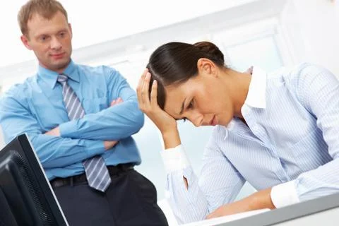 Portrait of young employee having trouble or headache with her boss at backgroun Stock Photos