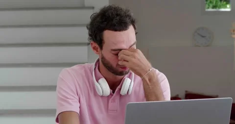 Portrait of a young exhausted overworked man, programmer entrepreneur Stock Footage 219904902