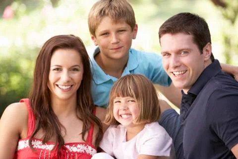Portrait Of Young Family Relaxing In Park Stock Photos