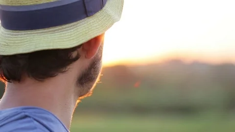 Portrait of young farmer in hat at sunset Stock Footage 77559243