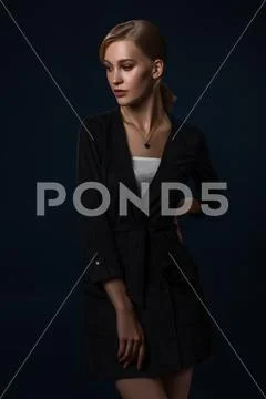 A portrait of a young fashionable woman in a black jumpsuit. Beauty, fashion. Stock Photos