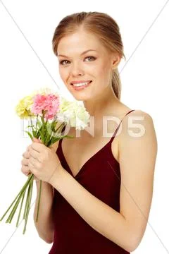 Portrait of a young female with bouquet of fresh carnations looking at camera Stock Photos
