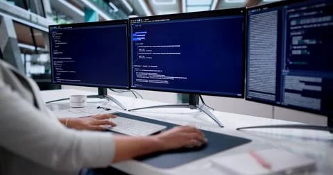 Portrait Of Young Female Coder Developing Software On Desktop Computer Stockfoto's