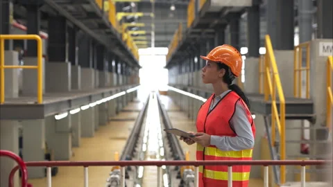 Portrait of a young female engineer standing in the skytrain repair station Stock Footage 274883354