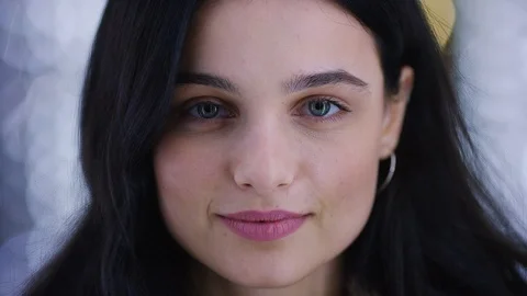 Portrait of young female looking to camera as lights strobe around her Stock Footage 100306591