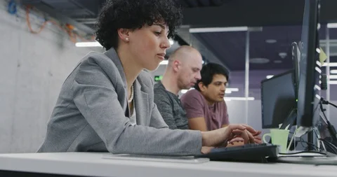 Portrait of young female software developer at busy startup office with multi Stock Footage 114086232