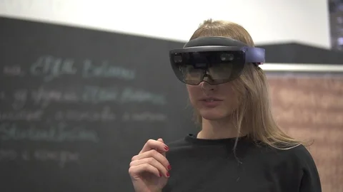 Portrait of young female using AR holographic hololens Stock Footage 87130630