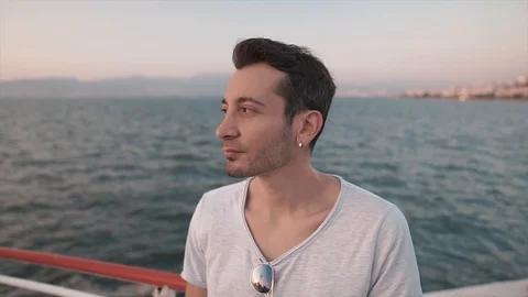 Portrait of young, five o'clock bearded handsome man near sea.  Stock Footage 112934116
