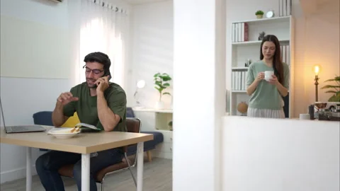 Portrait of a young freelancer smiling while working online via laptop 스톡 동영상 309012192