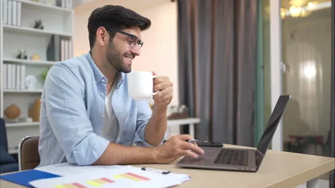 Portrait of a young freelancer smiling while working online via laptop at home Stock Footage 309014349