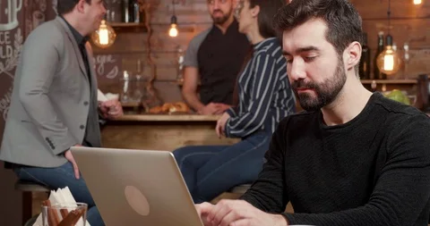 Portrait of a young freelancer typing and thinking about the text on his Stock Footage 103371029