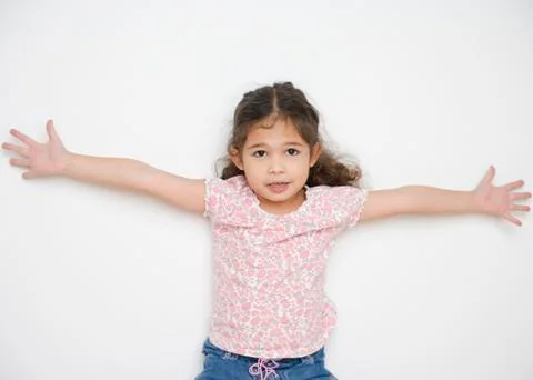 Portrait of young girl with arms spread open wide Stock Photos