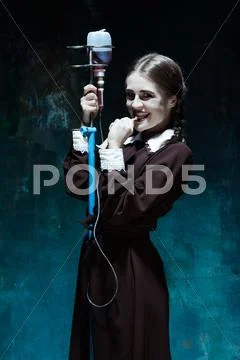 Portrait of a young girl in school uniform as a vampire woman Stock Photos