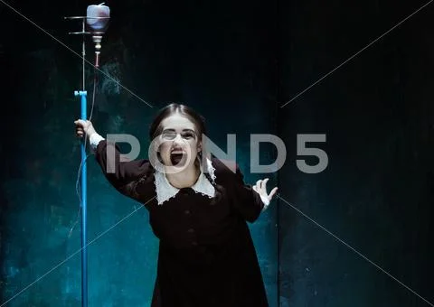 Portrait of a young girl in school uniform as a vampire woman Stock Photos