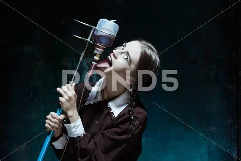 Portrait of a young girl in school uniform as a vampire woman Stock Photos