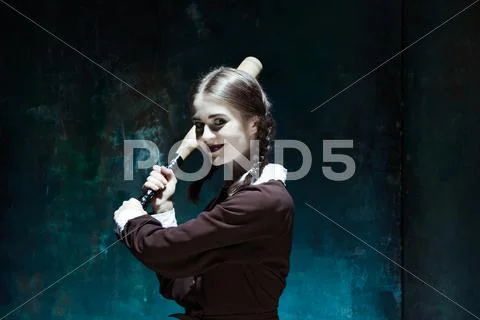 Portrait of a young girl in school uniform as killer woman Stock Photos