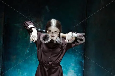 Portrait of a young girl in school uniform as killer woman Stock Photos