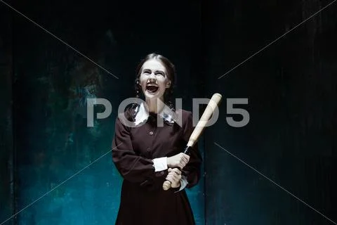 Portrait of a young girl in school uniform as killer woman Stock Photos