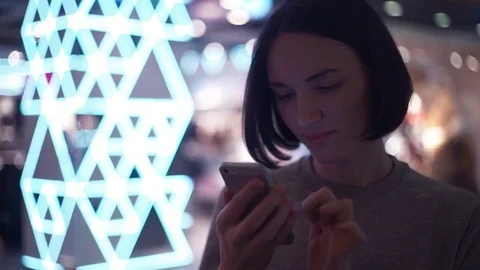 Portrait of young girl smiling using smartphone in shopping mall Stock Footage 83369233