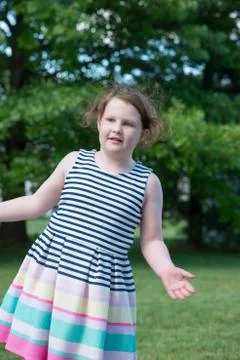 Portrait of Young Girl Standing in Backyard Stock Photos