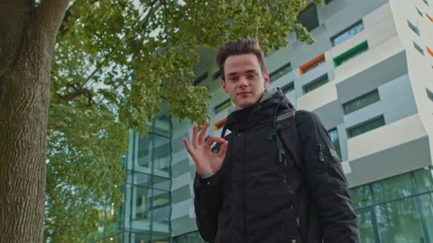 Portrait of a young guy close up, shooting from below. Stylishly dressed student Stock Footage 141720635