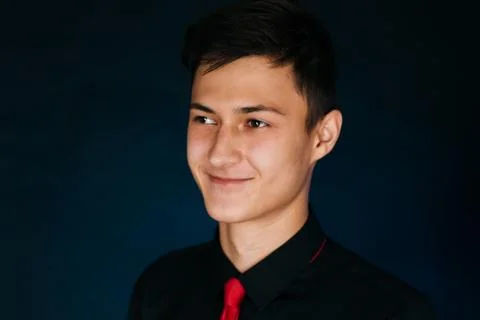 Portrait young guy on a dark studio Stock Photos