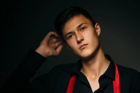 Portrait young guy on a dark studio Stock Photos