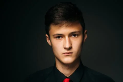 Portrait young guy on a dark studio Stock Photos