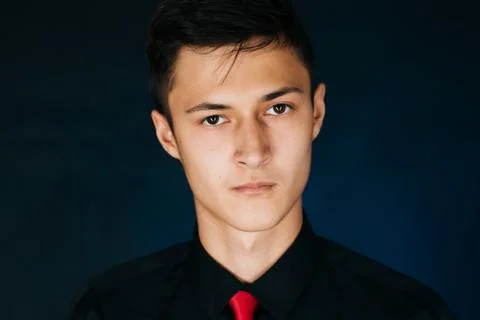Portrait young guy on a dark studio Stock Photos
